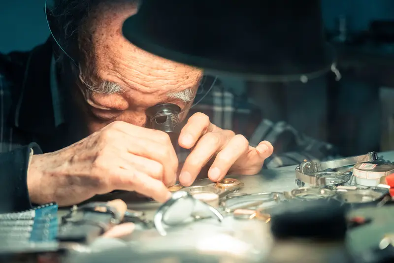 Watchmaker with a loupe at the bench